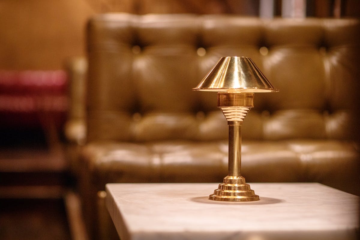 a close up of a glass vase sitting on top of a wooden table