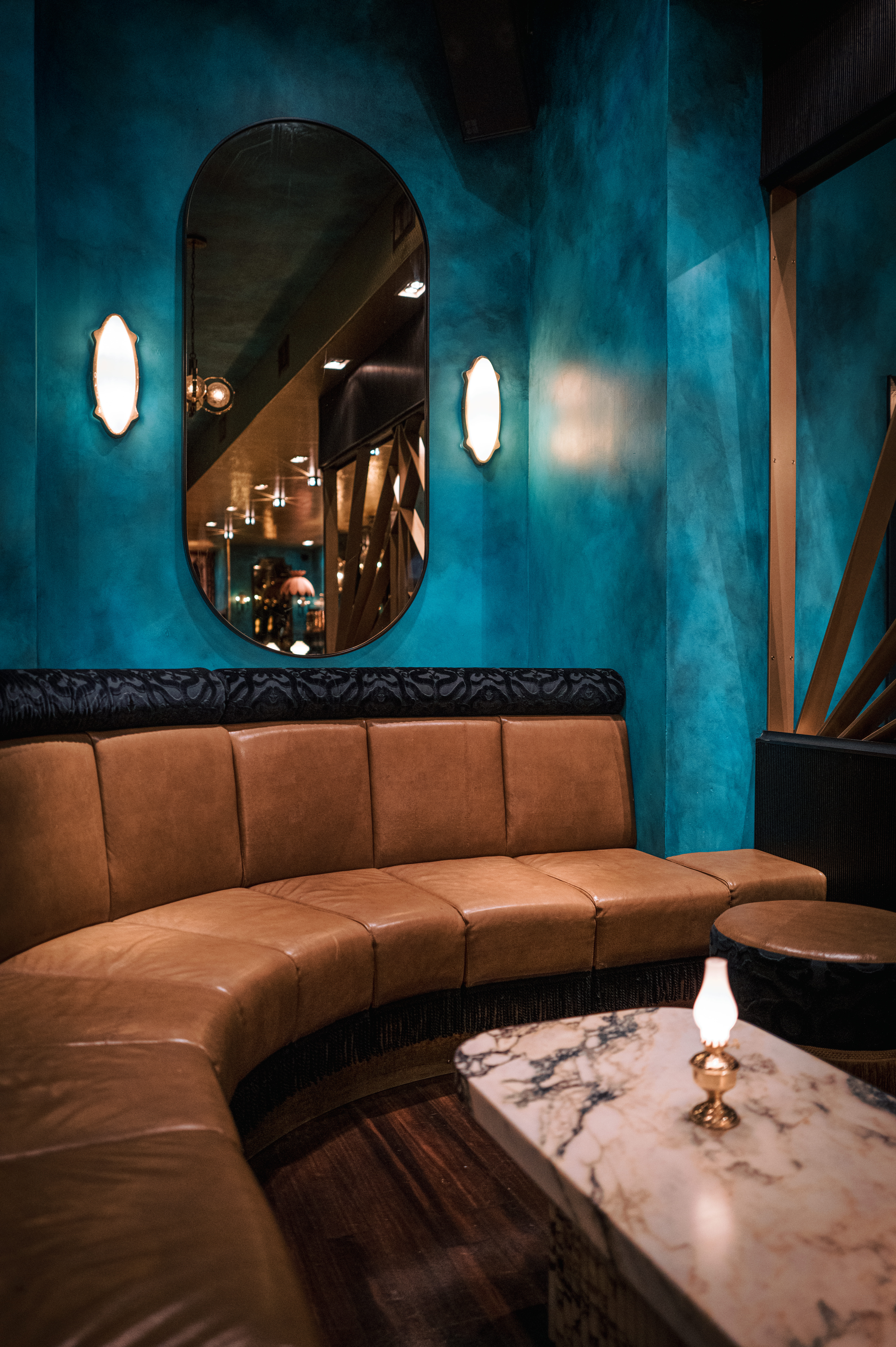 a leather chair sitting next to a fireplace