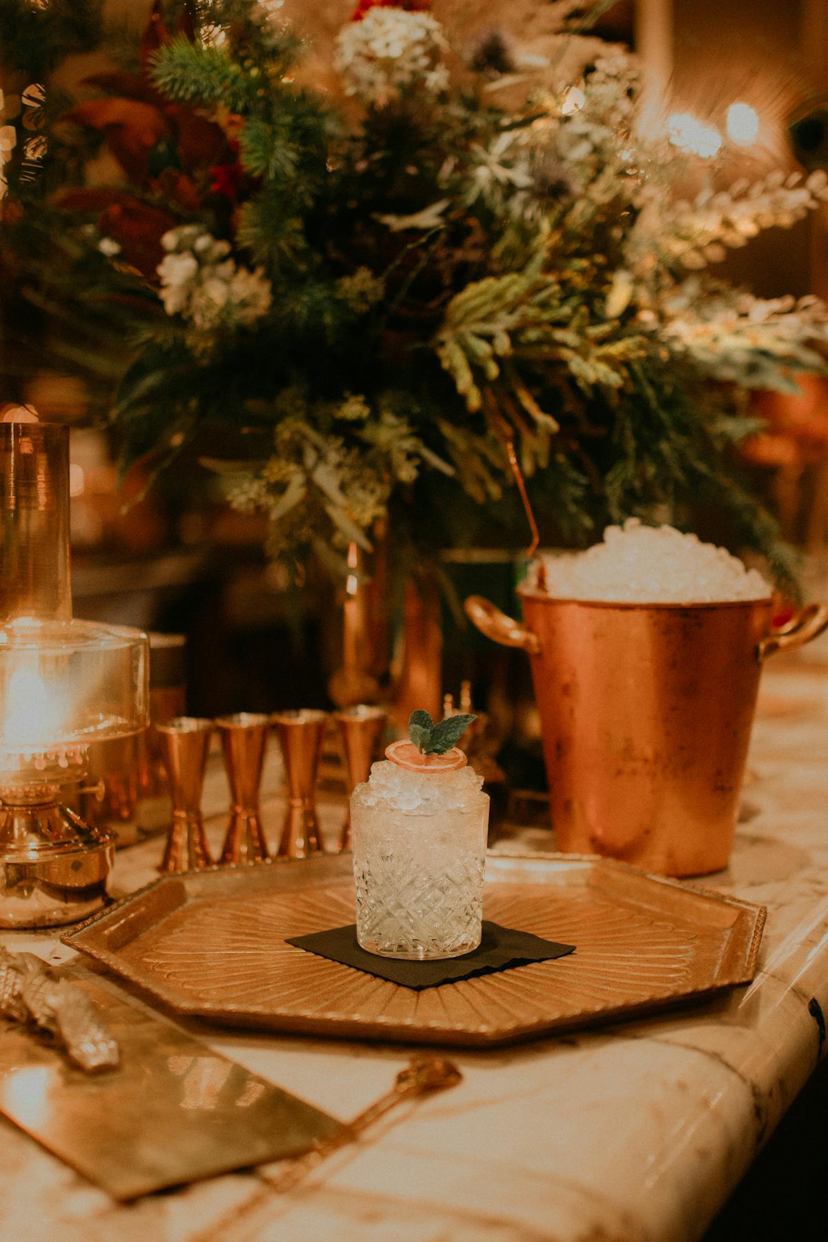 a vase of flowers sitting on top of a wooden table