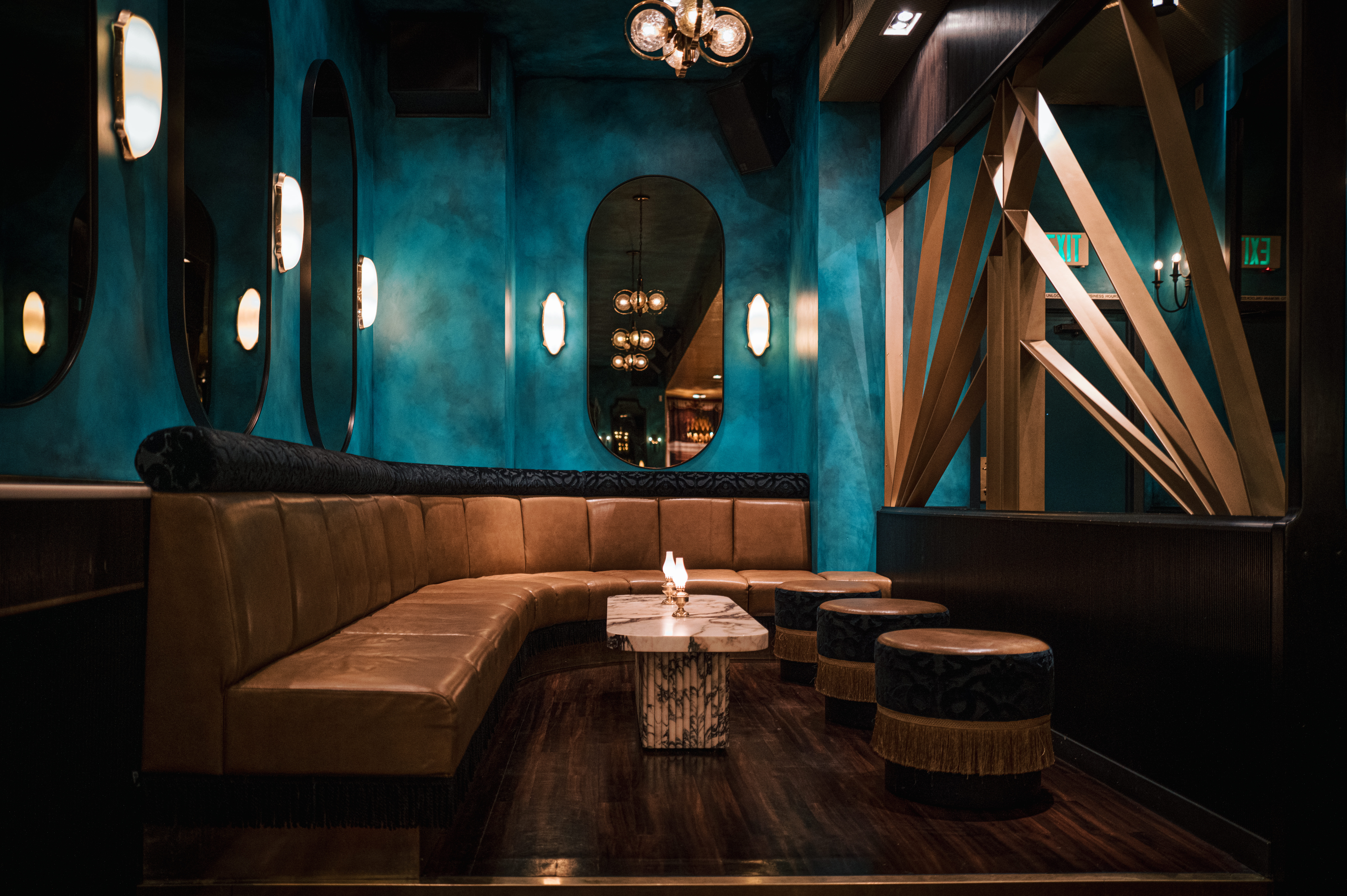 a person sitting at a table in front of a mirror