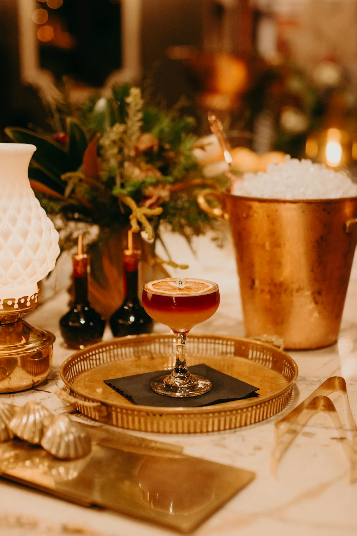 a glass of beer on a table with wine glasses