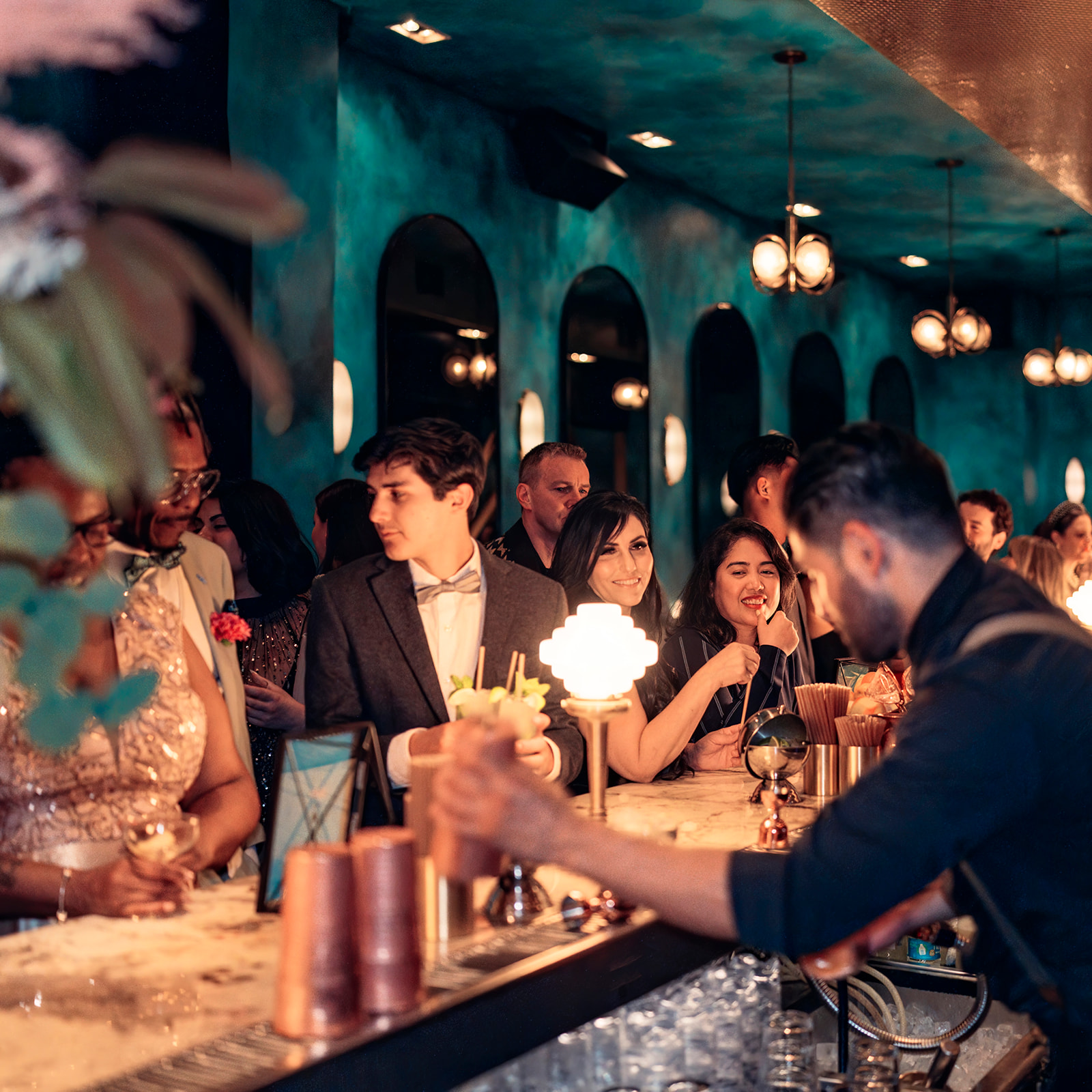 a group of people sitting at a table with a birthday cake