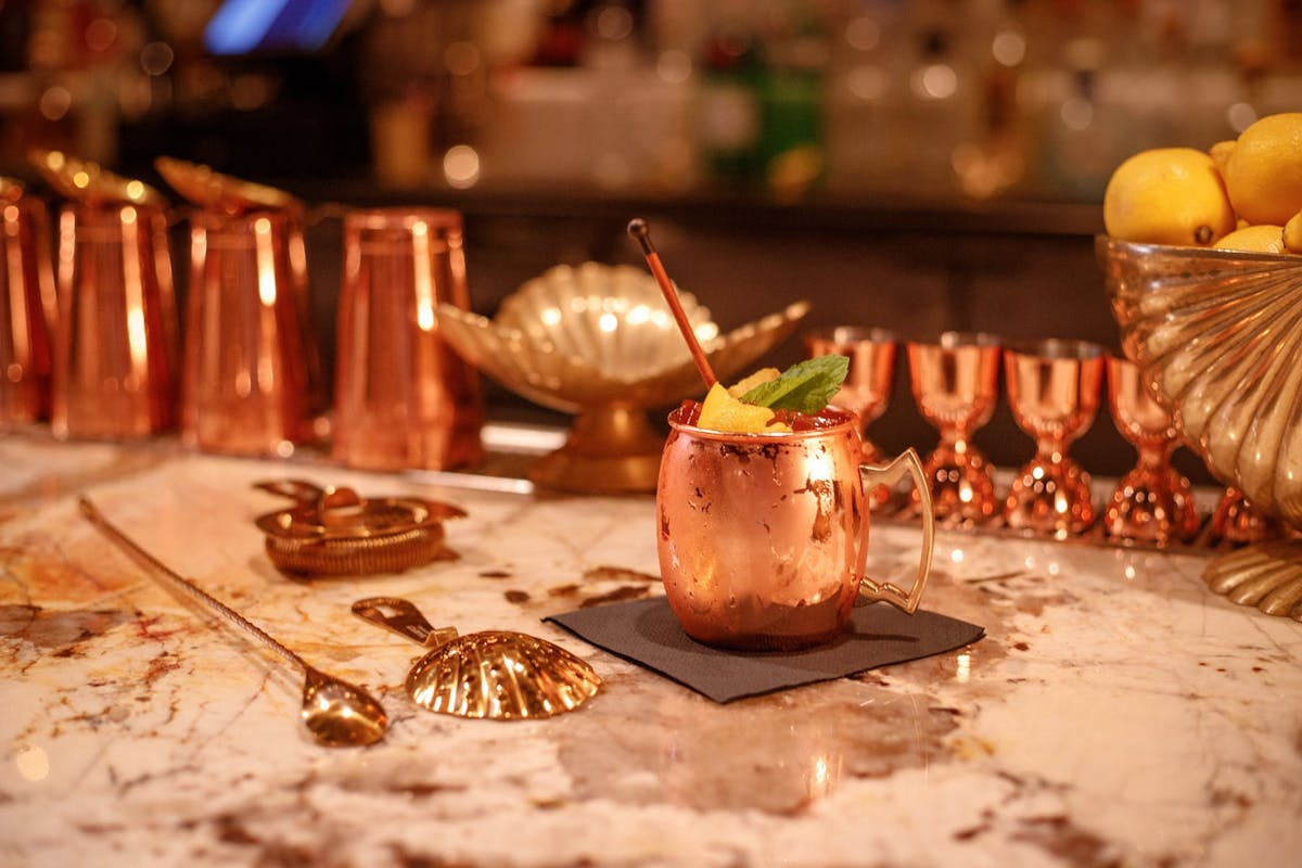 a piece of cake sitting on top of a table with wine glasses