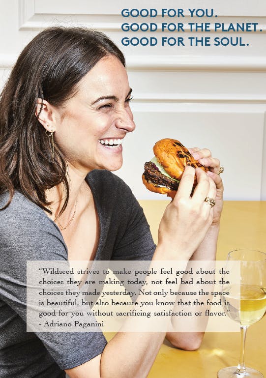 a woman holding a sandwich