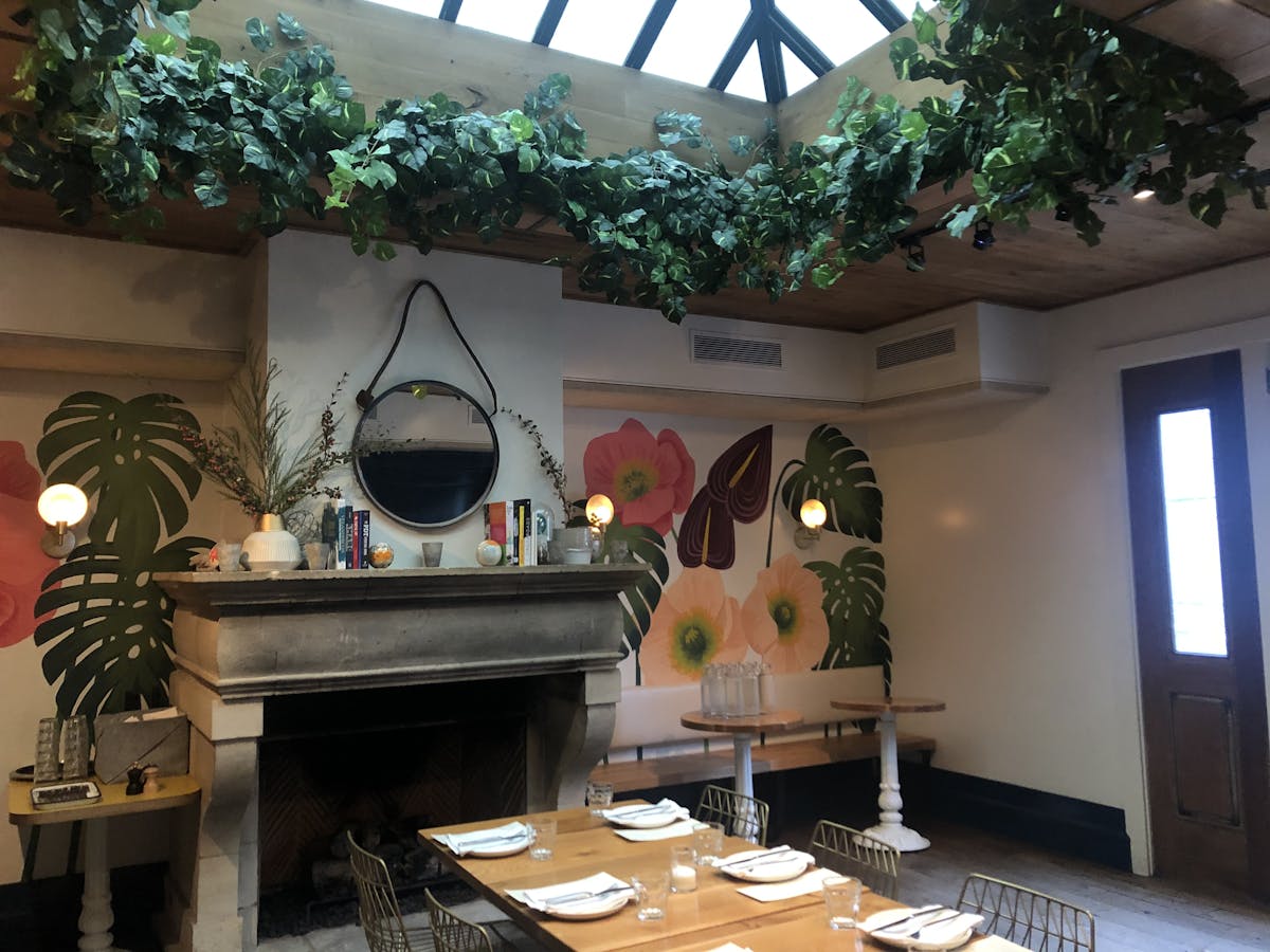 a room filled with furniture and vase of flowers on a table