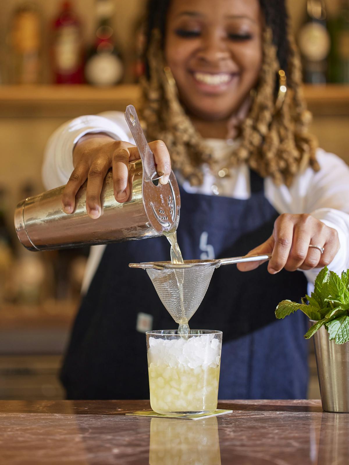 a woman cutting a piece of cake on a table