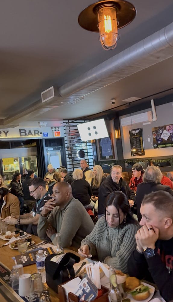 a group of people sitting at a table in a restaurant