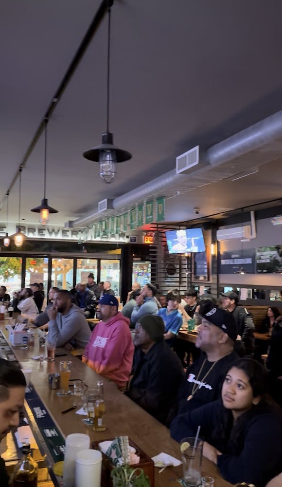 a group of people sitting at a table in a restaurant