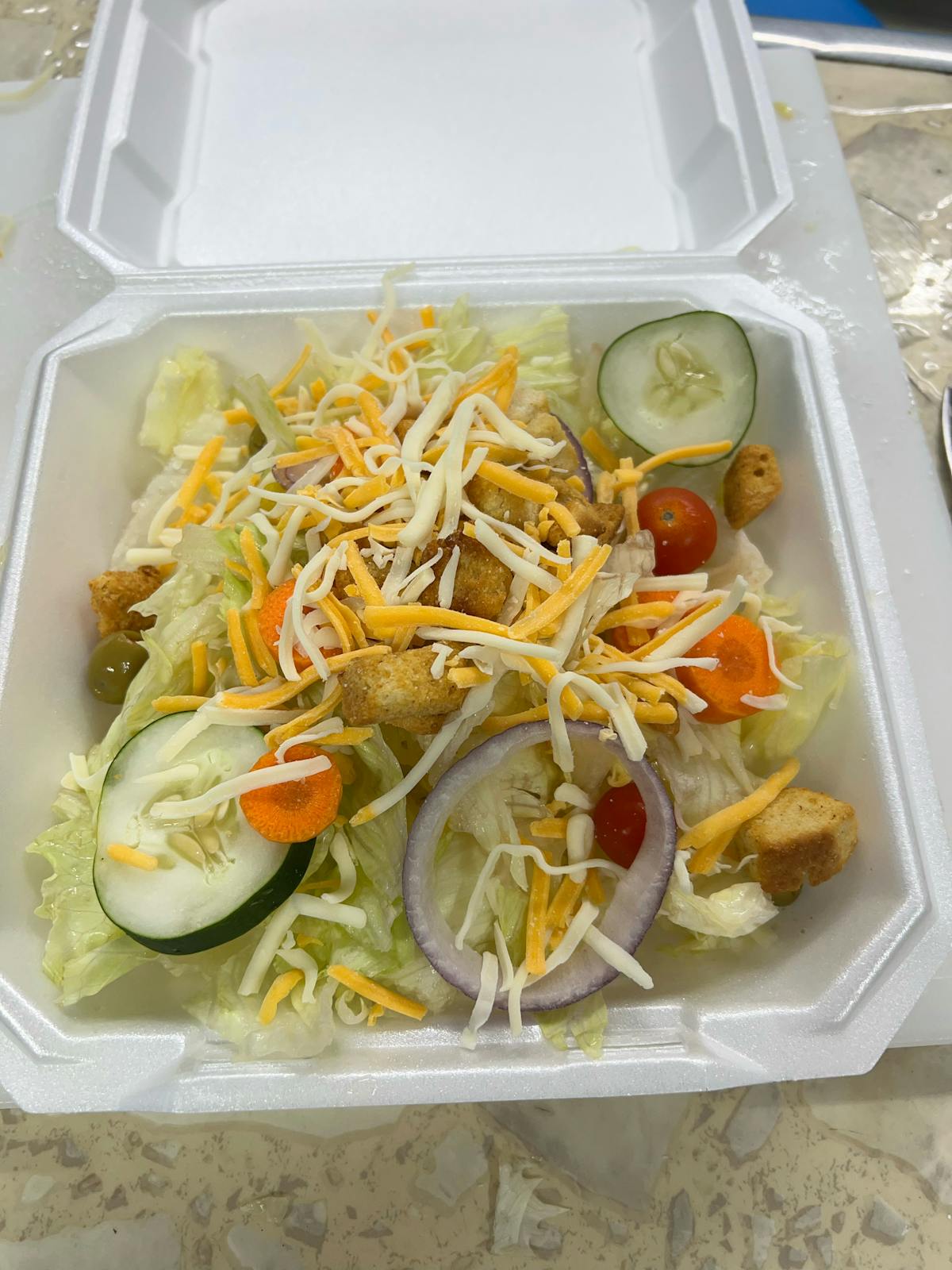 a plastic container filled with different types of food on a tray