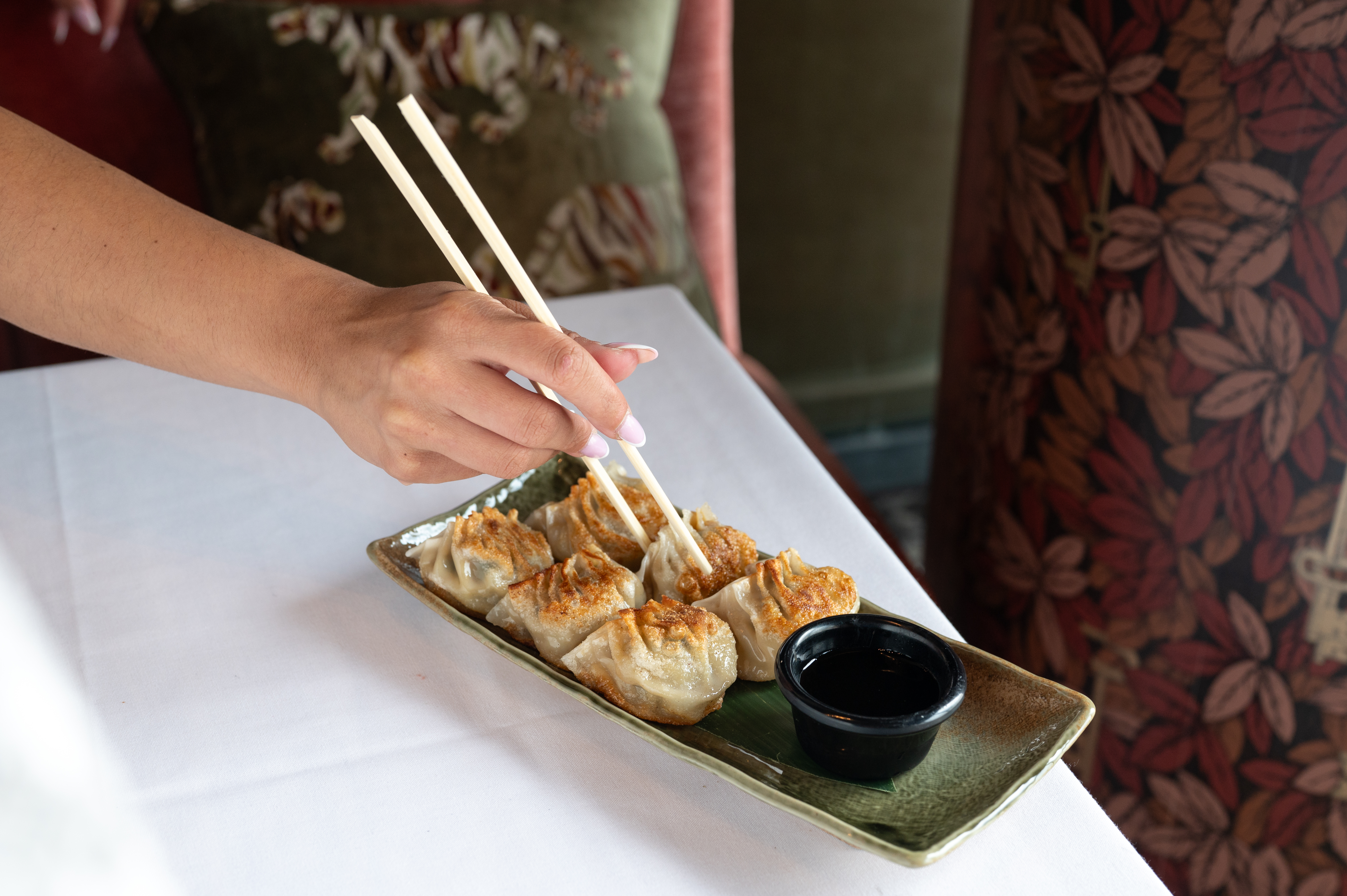 a person sitting at a table with a plate of food