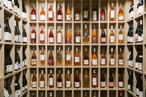 a row of wine glasses sitting on a shelf