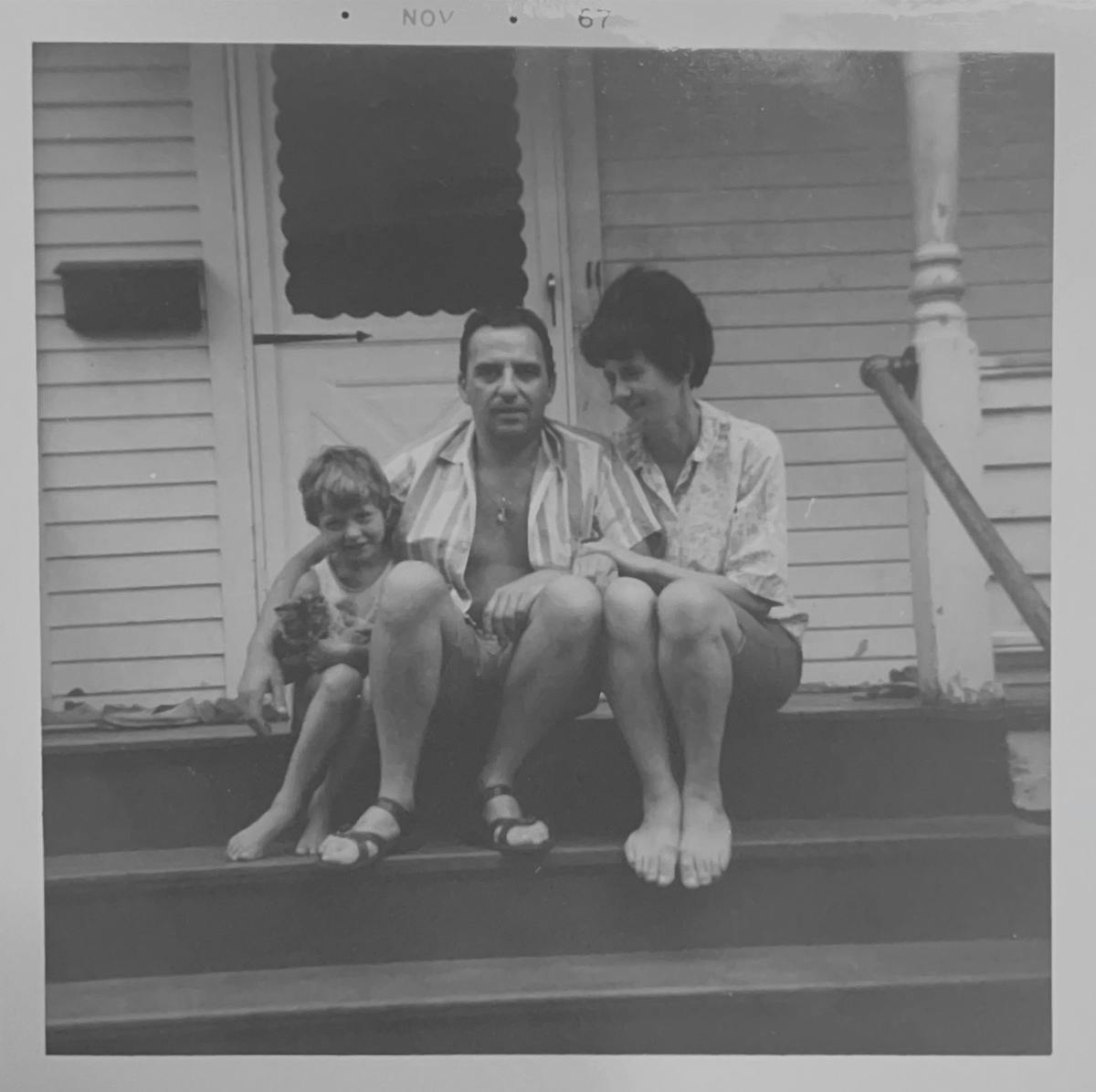 a group of people posing for a photo in front of a window