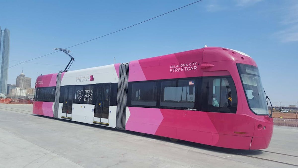 a passenger bus that is parked on the side of a road