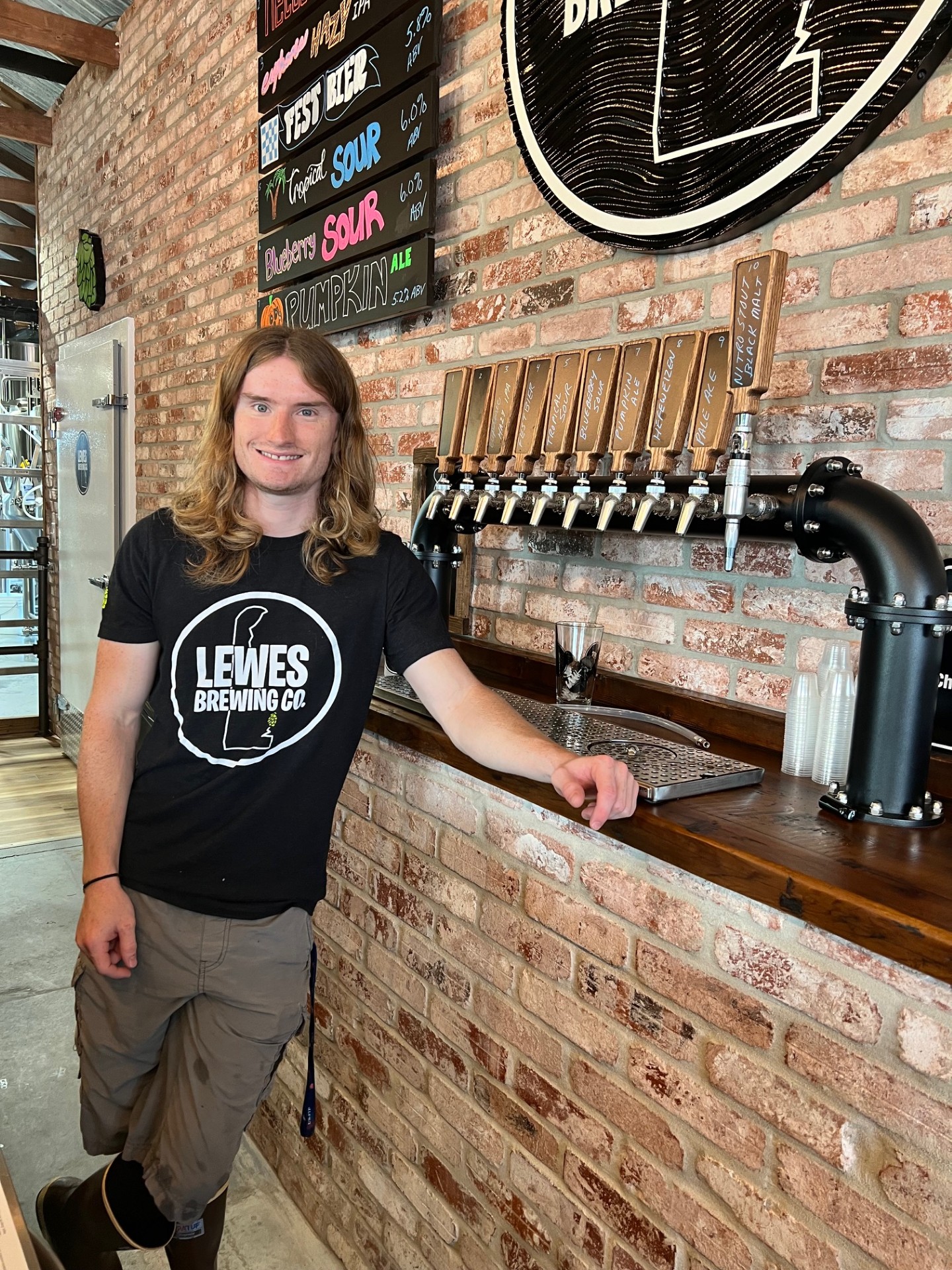 a man standing in front of a brick building