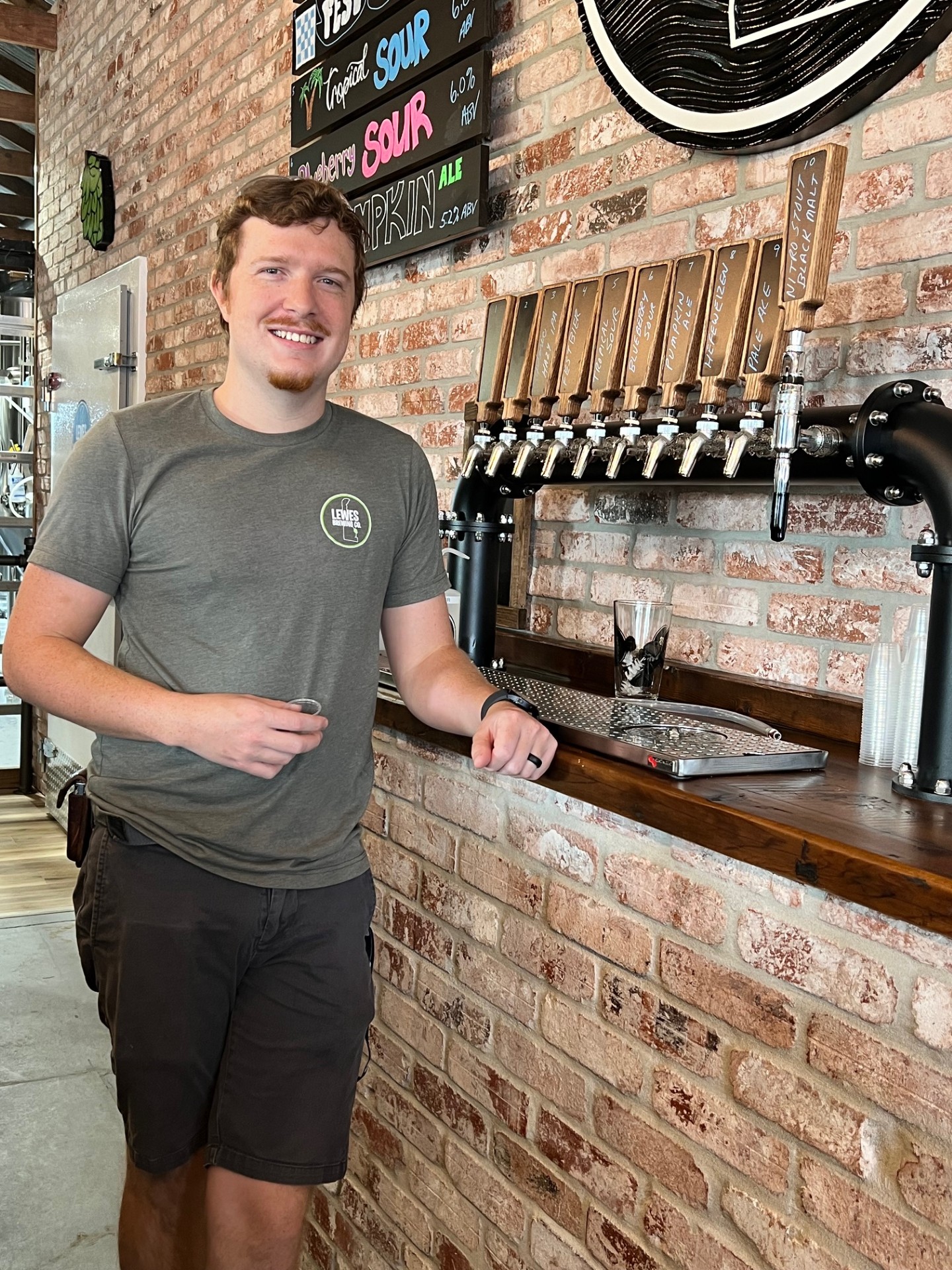 a person standing in front of a brick building