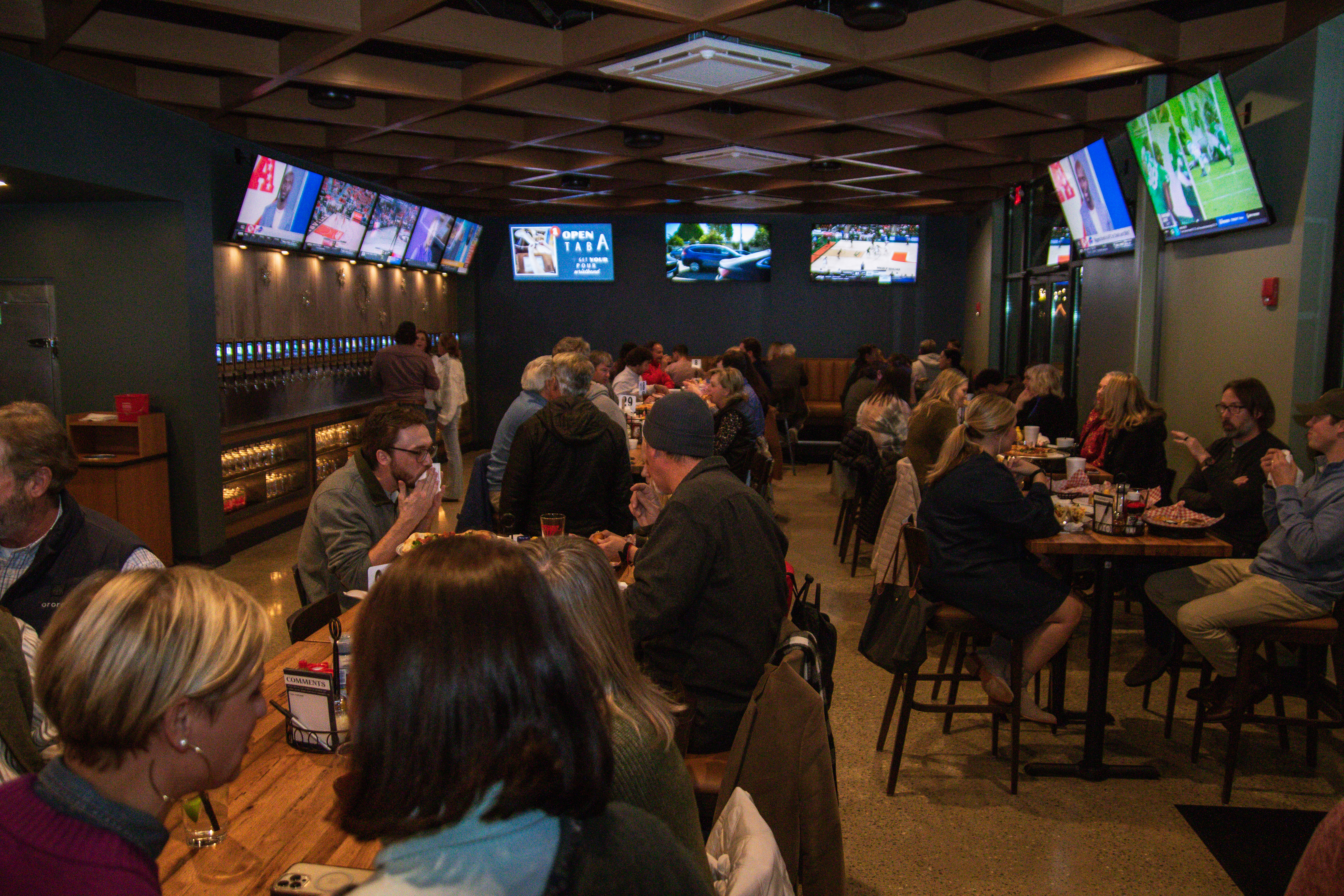 a group of people sitting at a table in front of a crowd
