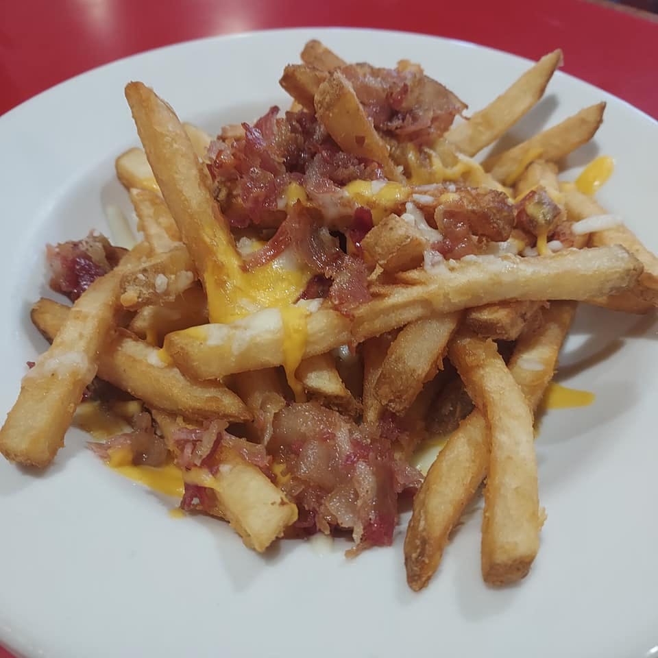 a plate of food that is on the side of fries