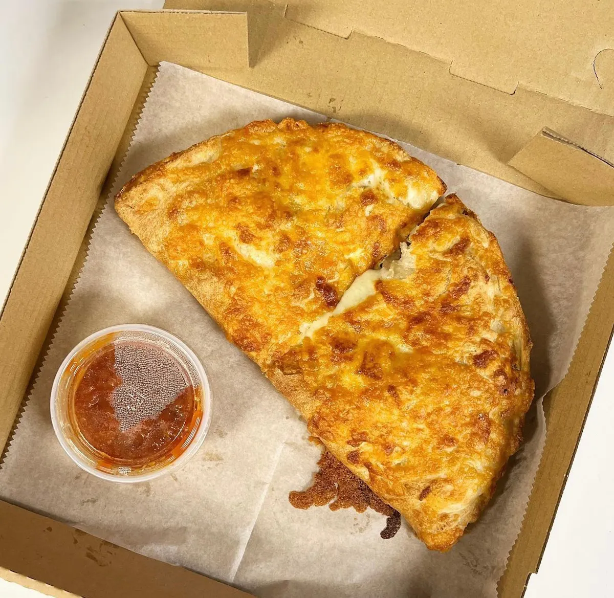 a slice of pizza sitting on top of a box