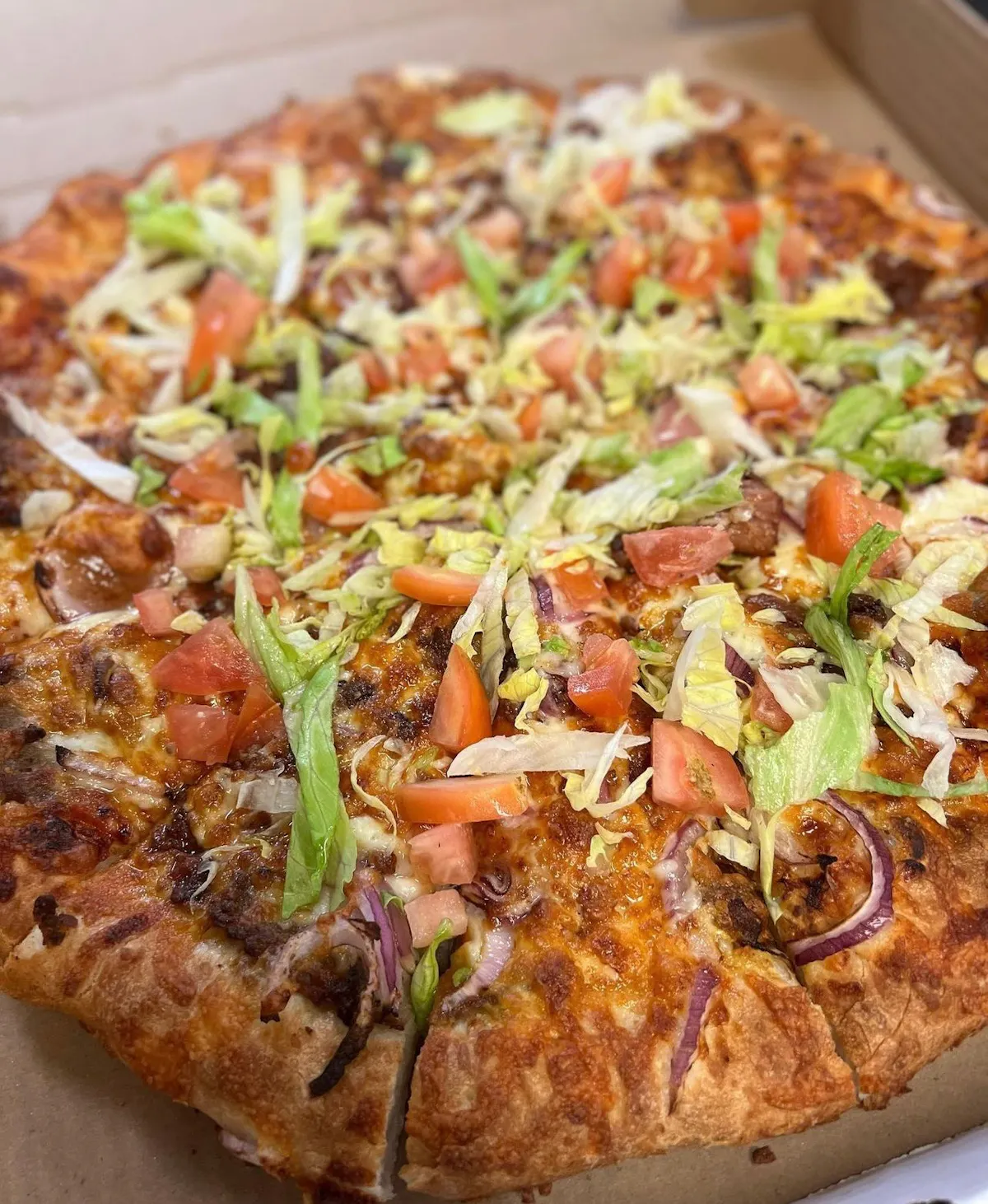 a close up of a box of pizza