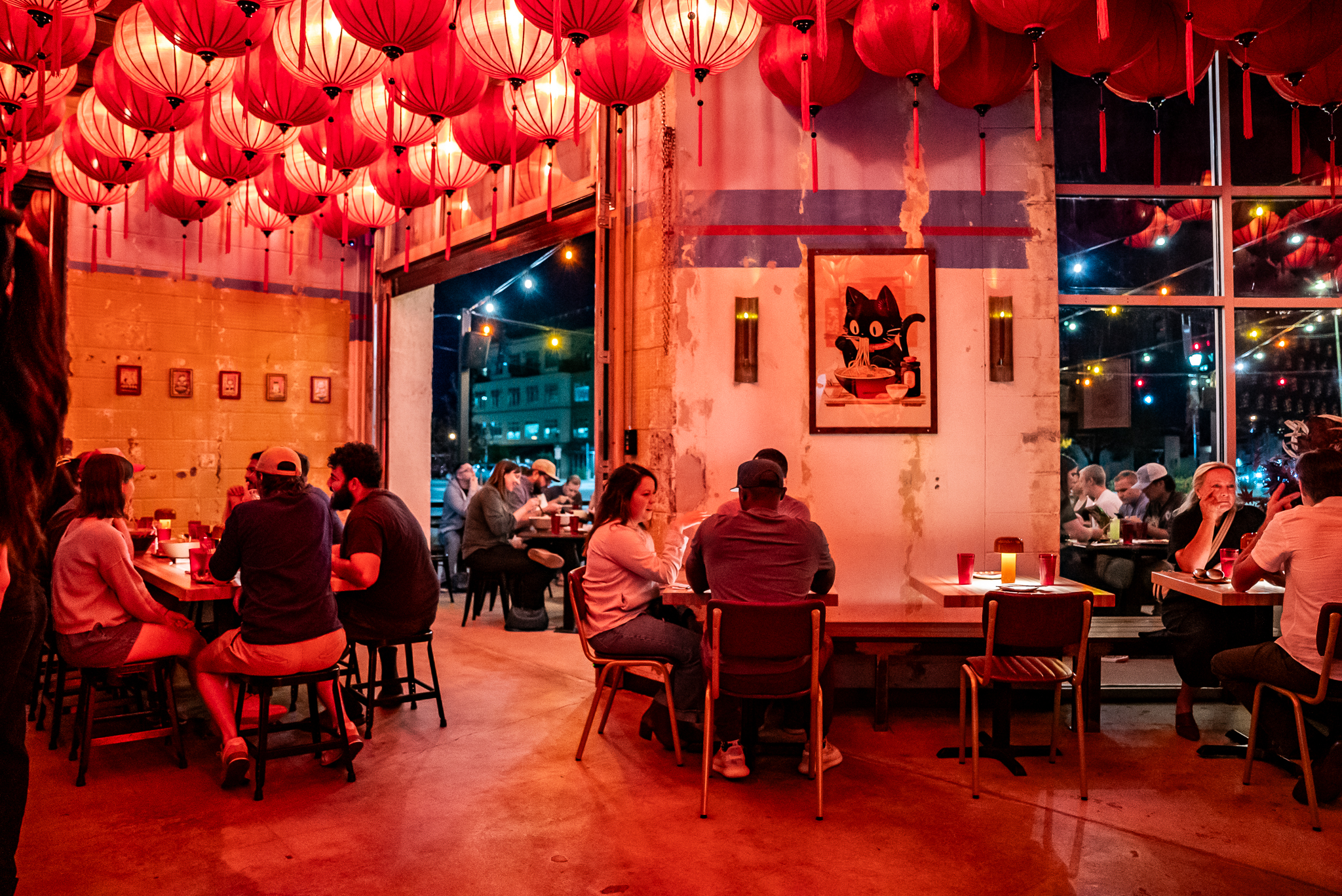 a group of people sitting at a table in a restaurant