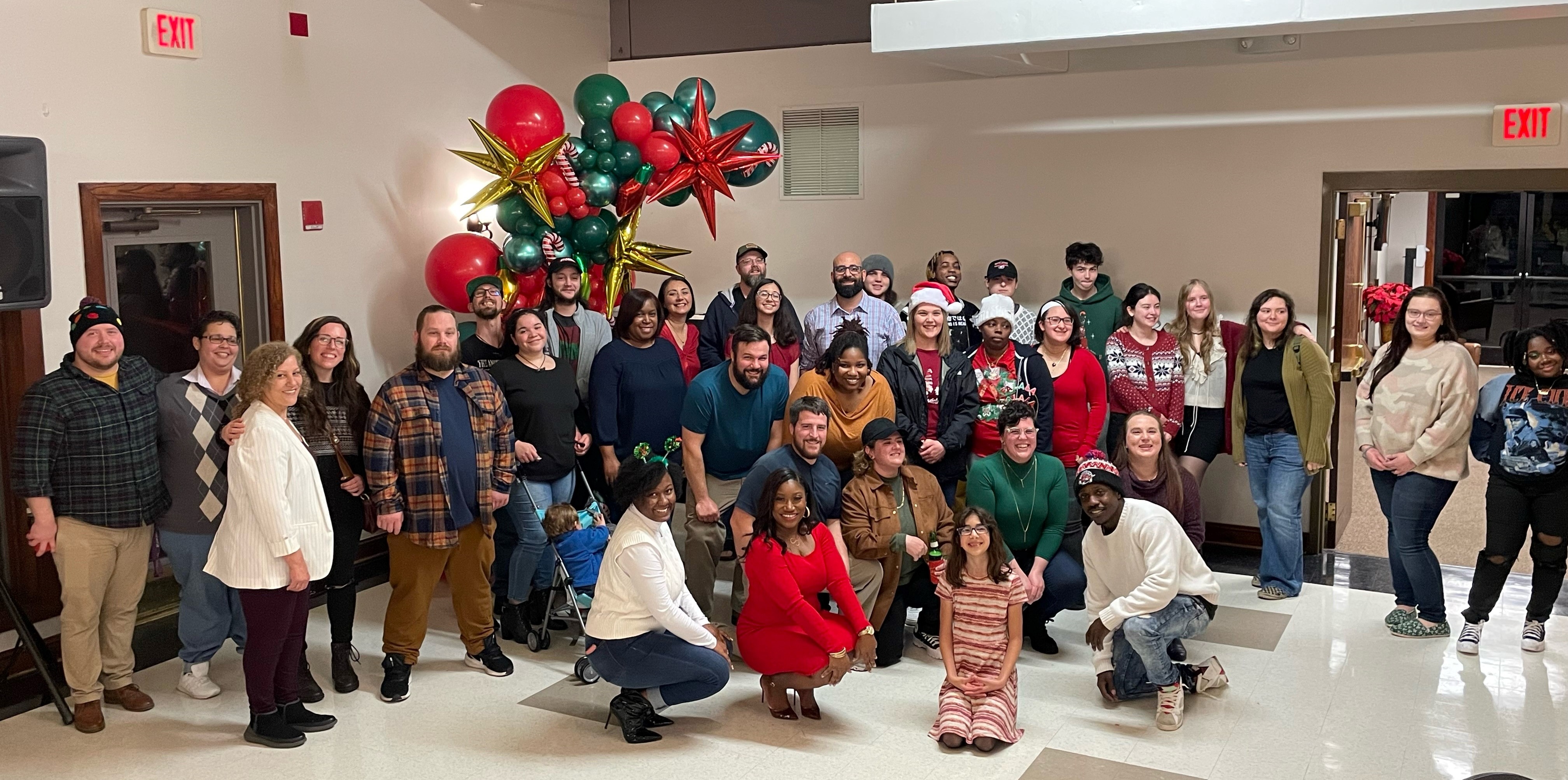 a group of people standing in front of a crowd posing for the camera