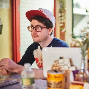 a person sitting at a table eating food