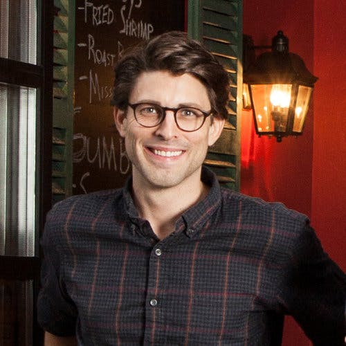 a man sitting at a table in a restaurant