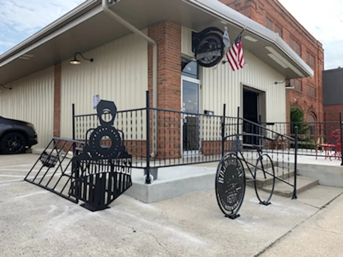 a bench in front of a brick building