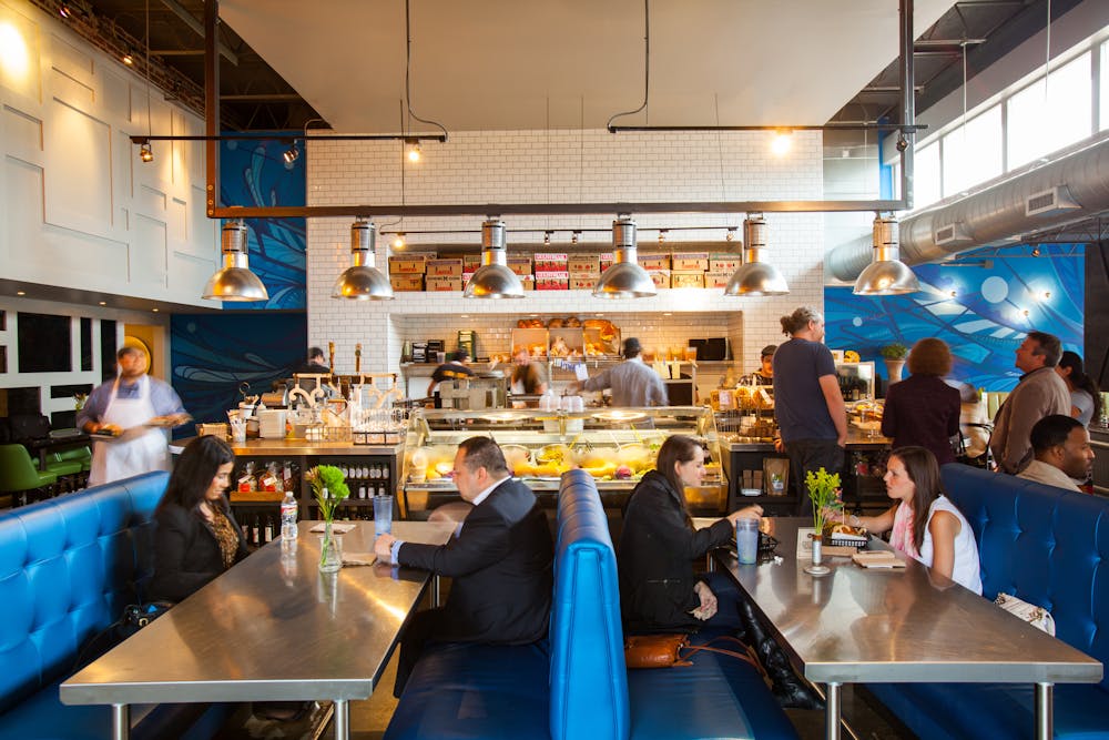 a group of people sitting at a table in a restaurant