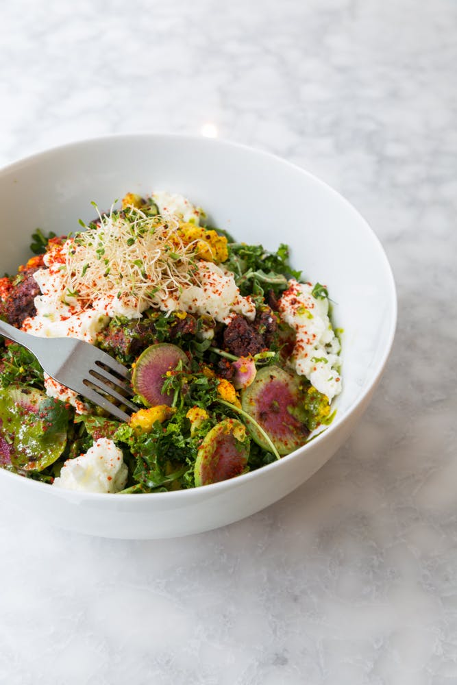 a bowl of food with broccoli