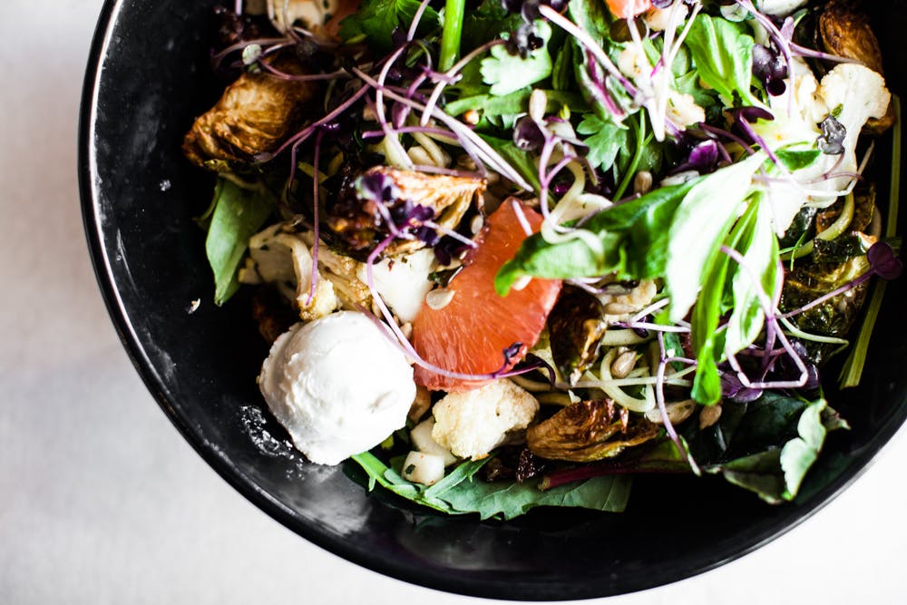 a bowl of salad on a plate