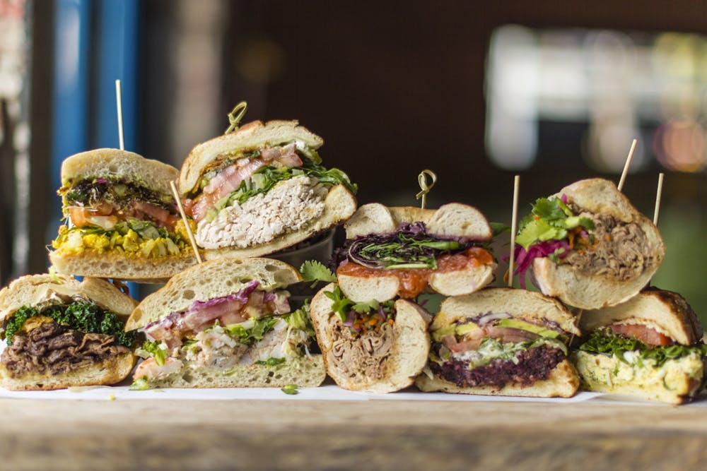 a close up of a sandwich on a cutting board with a cake