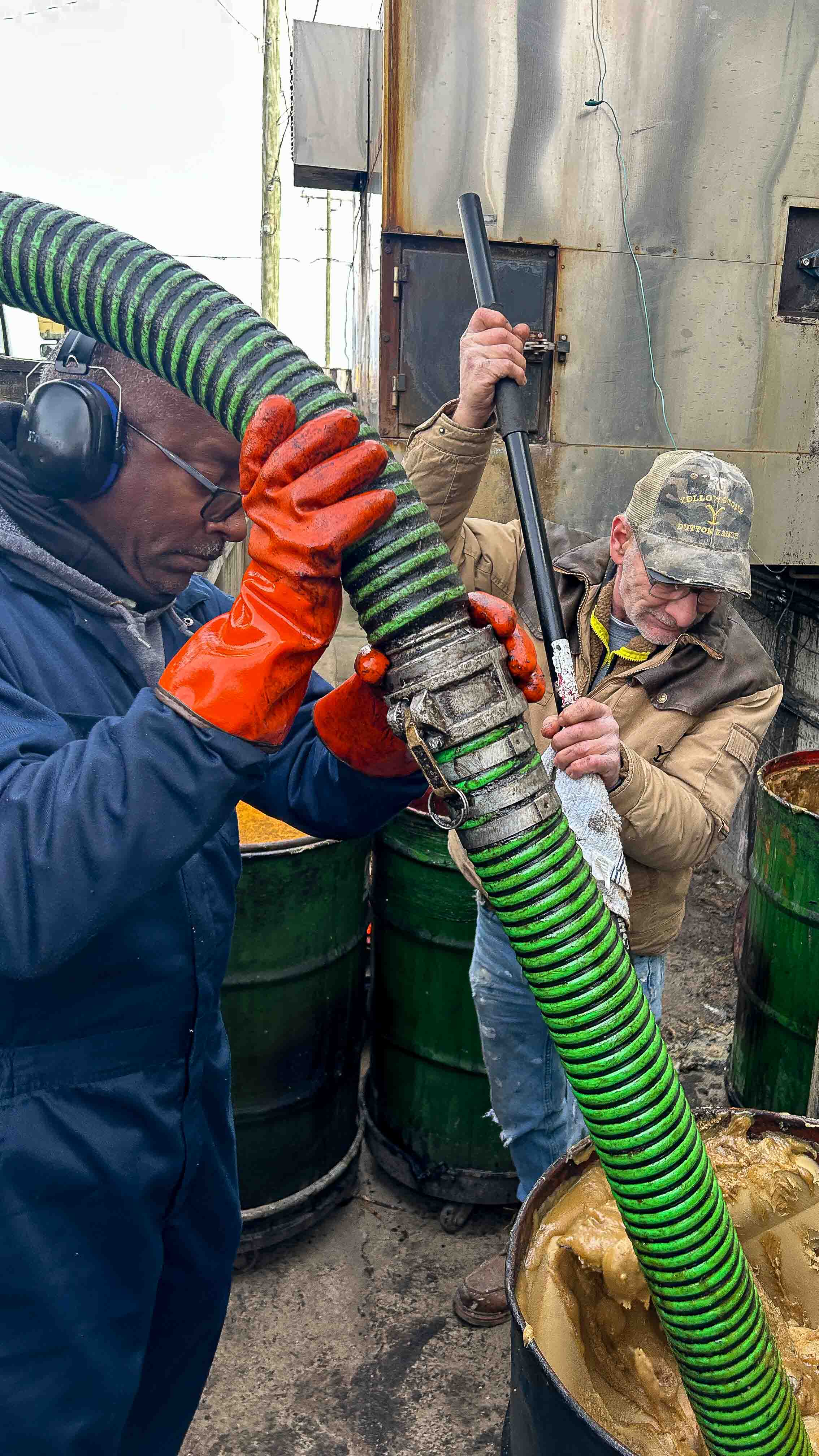 a group of men working on a pipe