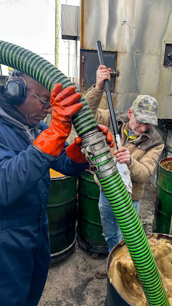 a group of men working on a pipe