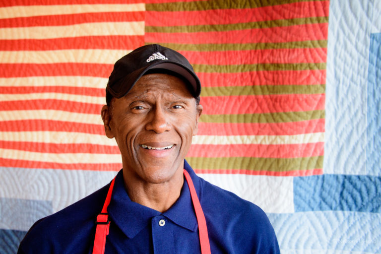 a man wearing a neck tie and a hat