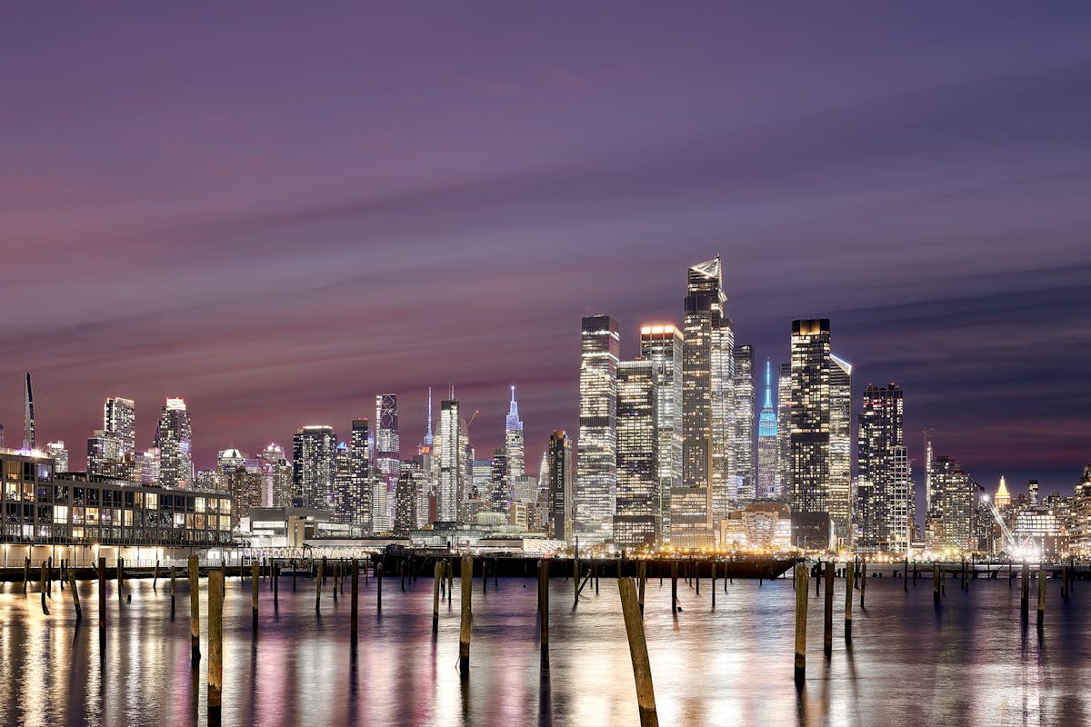 a bridge over a body of water with a city in the background