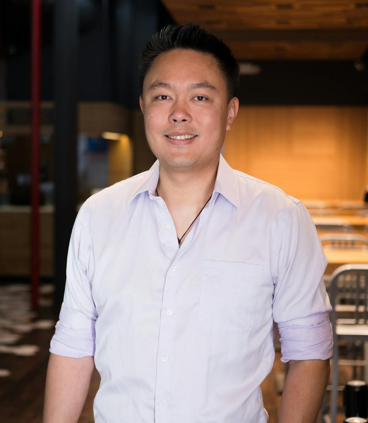 a smiling man in a white shirt