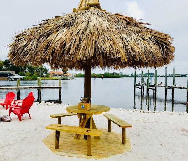 a row of beach chairs and an umbrella