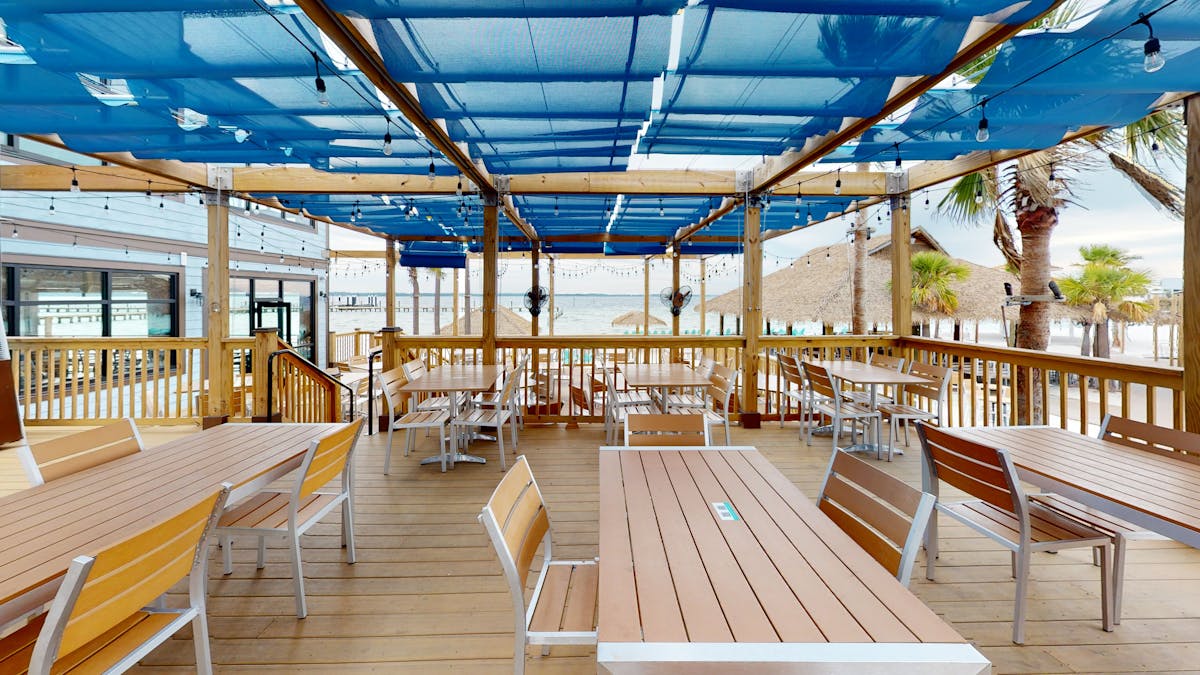 a dining room table in front of a fence