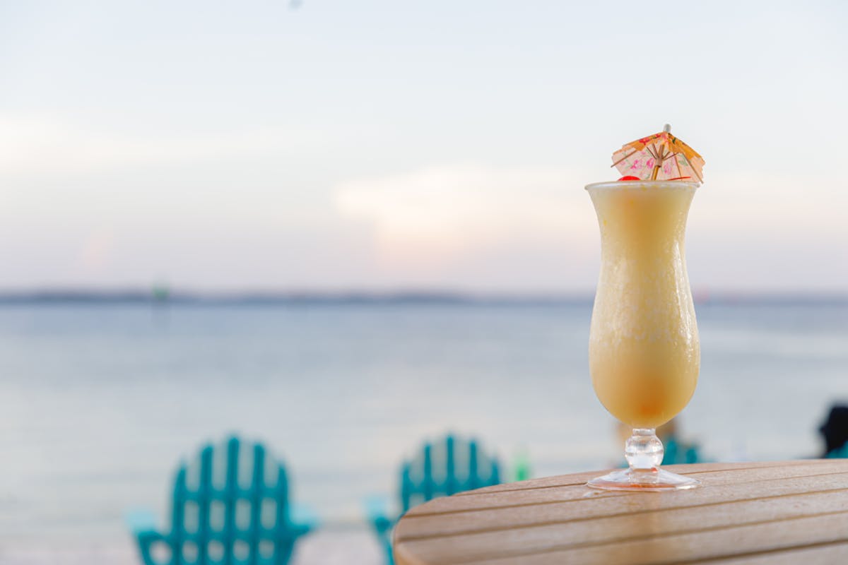 a cocktail on a table with an ocean view