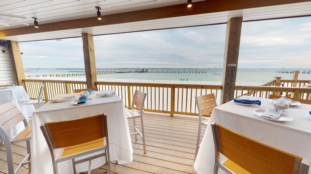 tables next to windows facing the beach