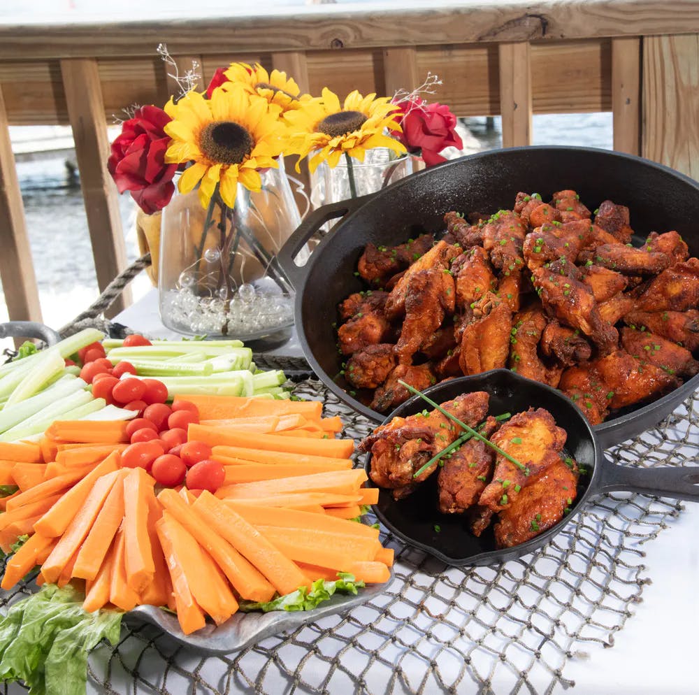 Vegetables and chicken wings on a table