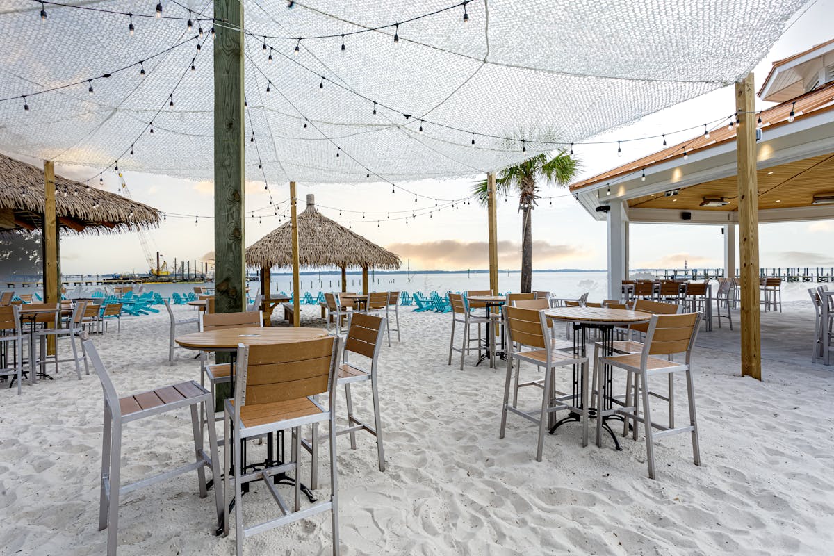 tables, chairs, and umbrellas on the beach