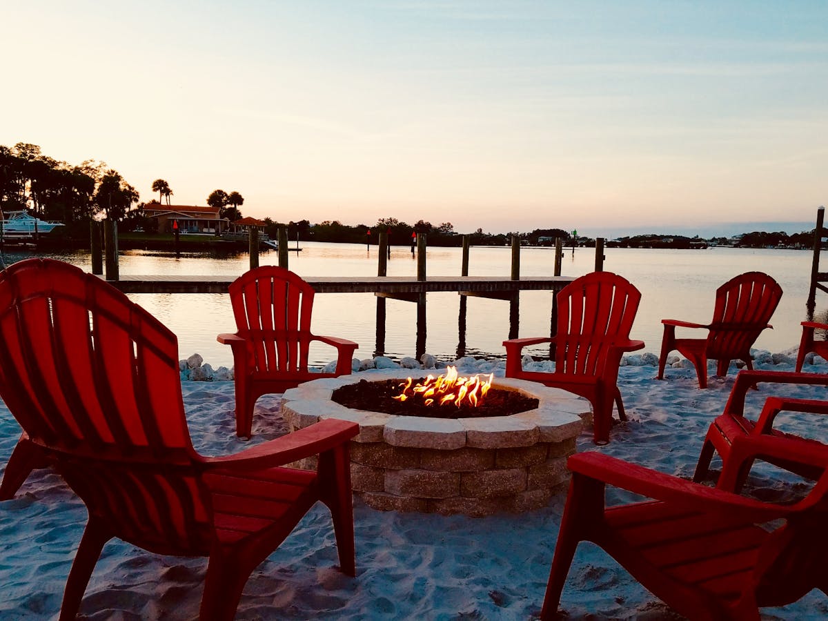 chairs around a fire pit on the beach