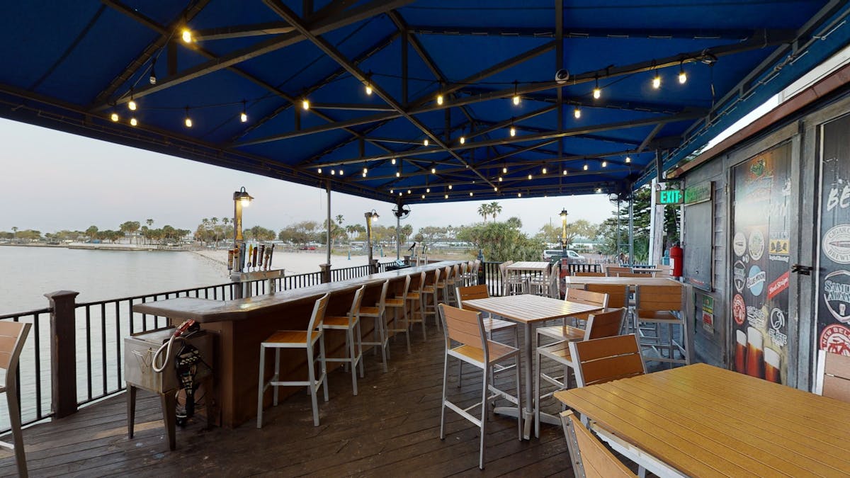 a covered patio with string lights