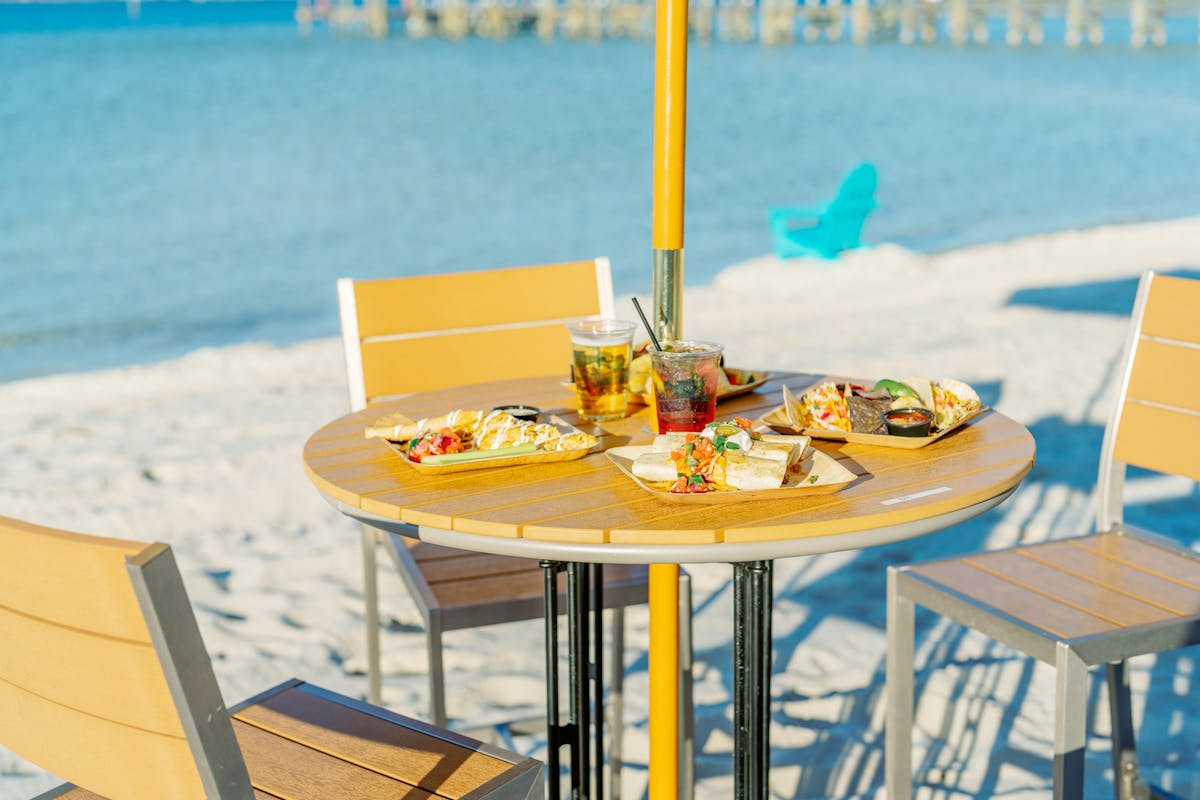 plates of food on a table on the beach