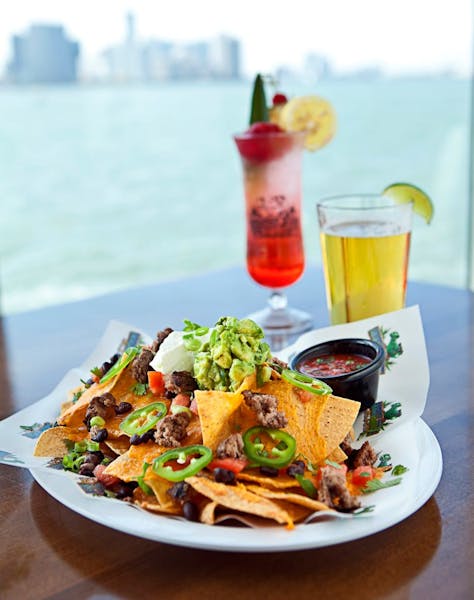 nachos and cocktails on a table