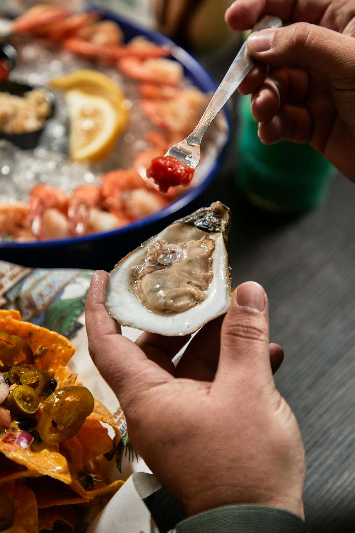 a close up of a person holding an oyster