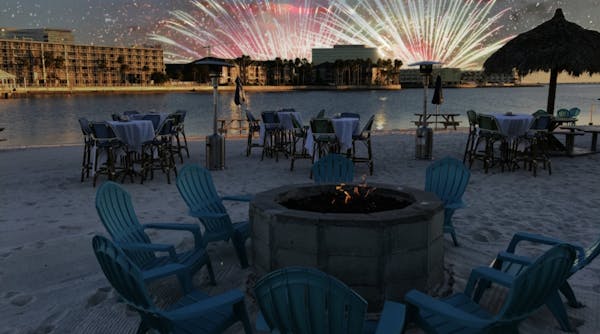 a group of lawn chairs sitting on top of a beach