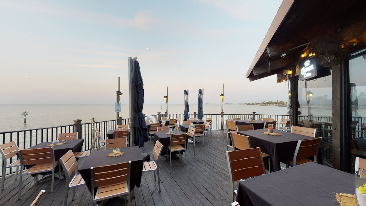 a patio with tables and chairs